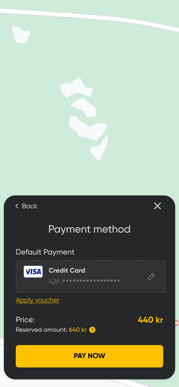 Payment method sheet over the map: default Visa credit card, Apply voucher, the price, the reserved amount and Pay now.